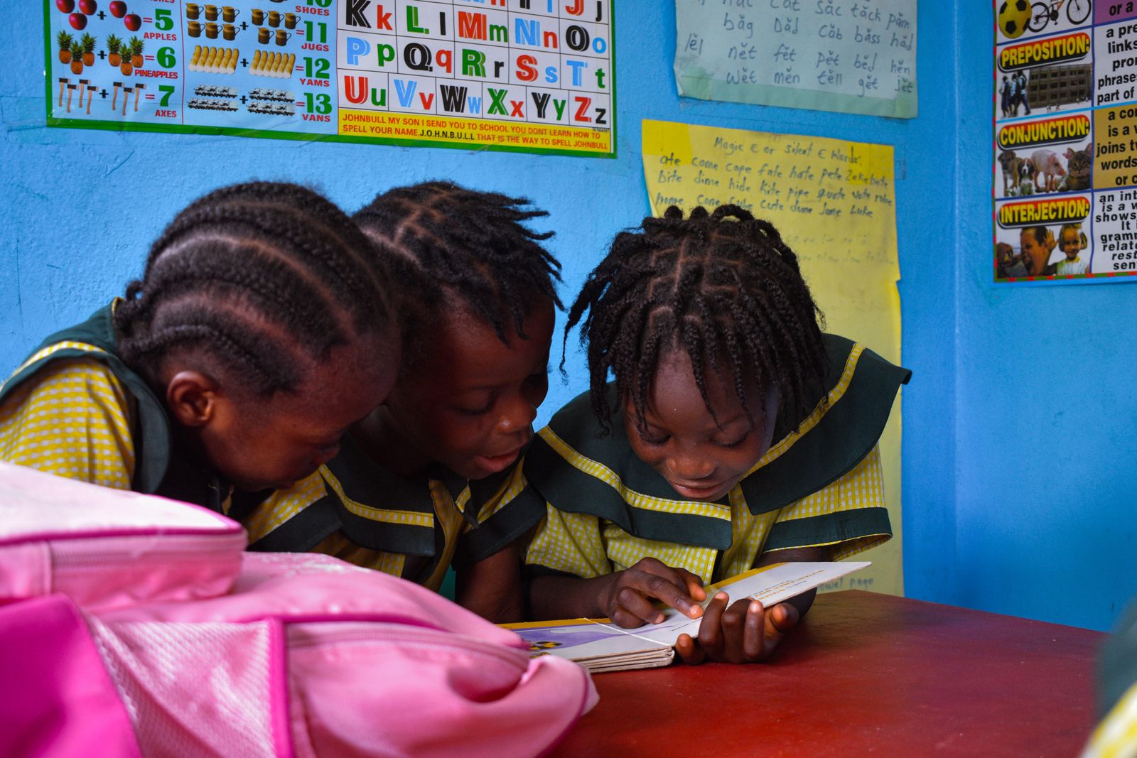 Illustrative pupils reading together in a classroom, not the actual school or pupils